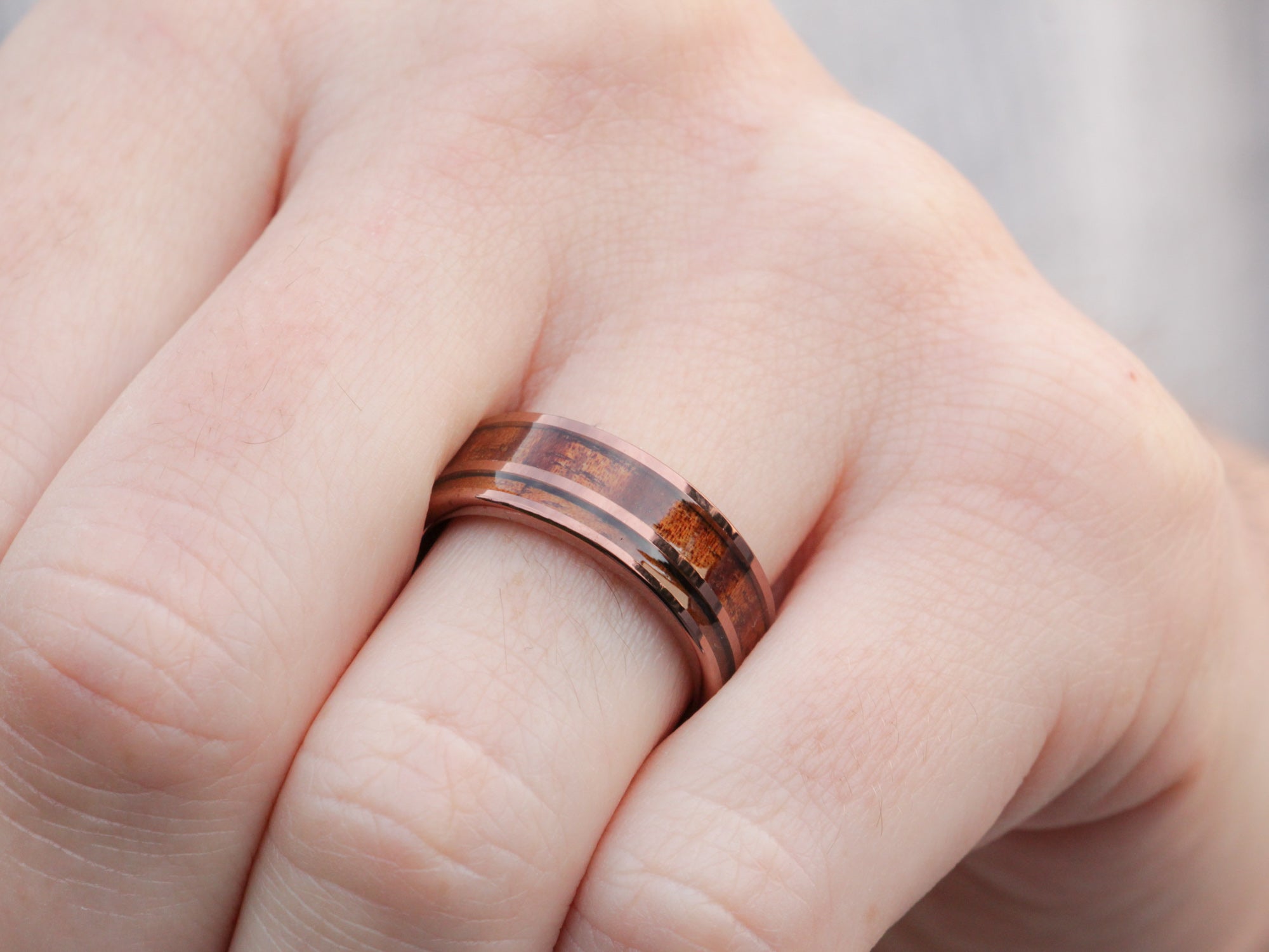 koa wood tunsten ring, curly koa wood dual inlay, 8mm polished brown wedding band, mens hand photo