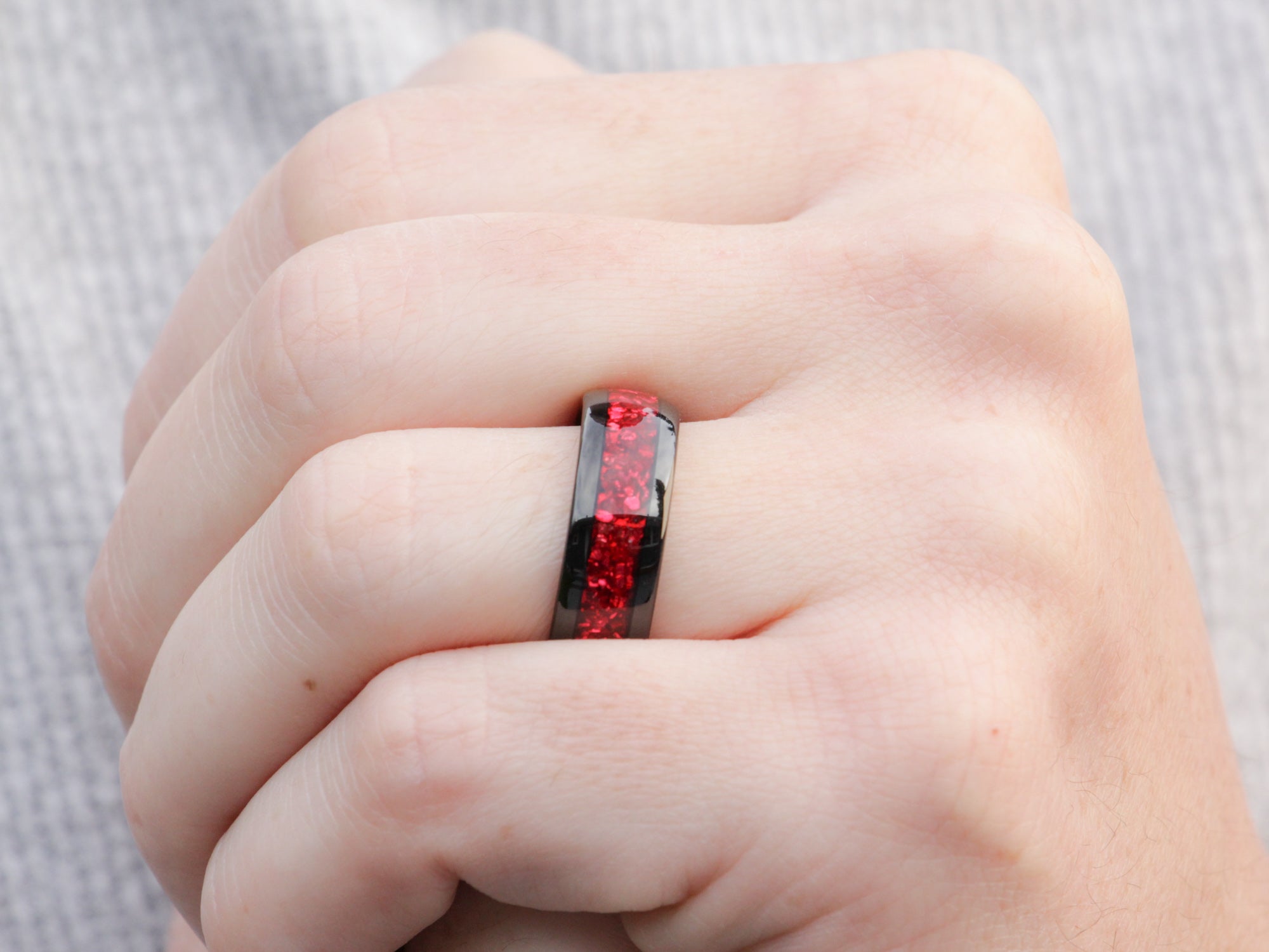 red garnet tungsten ring, lab garnet gemstone inlay, 8mm polished black wedding band, mens hand photo