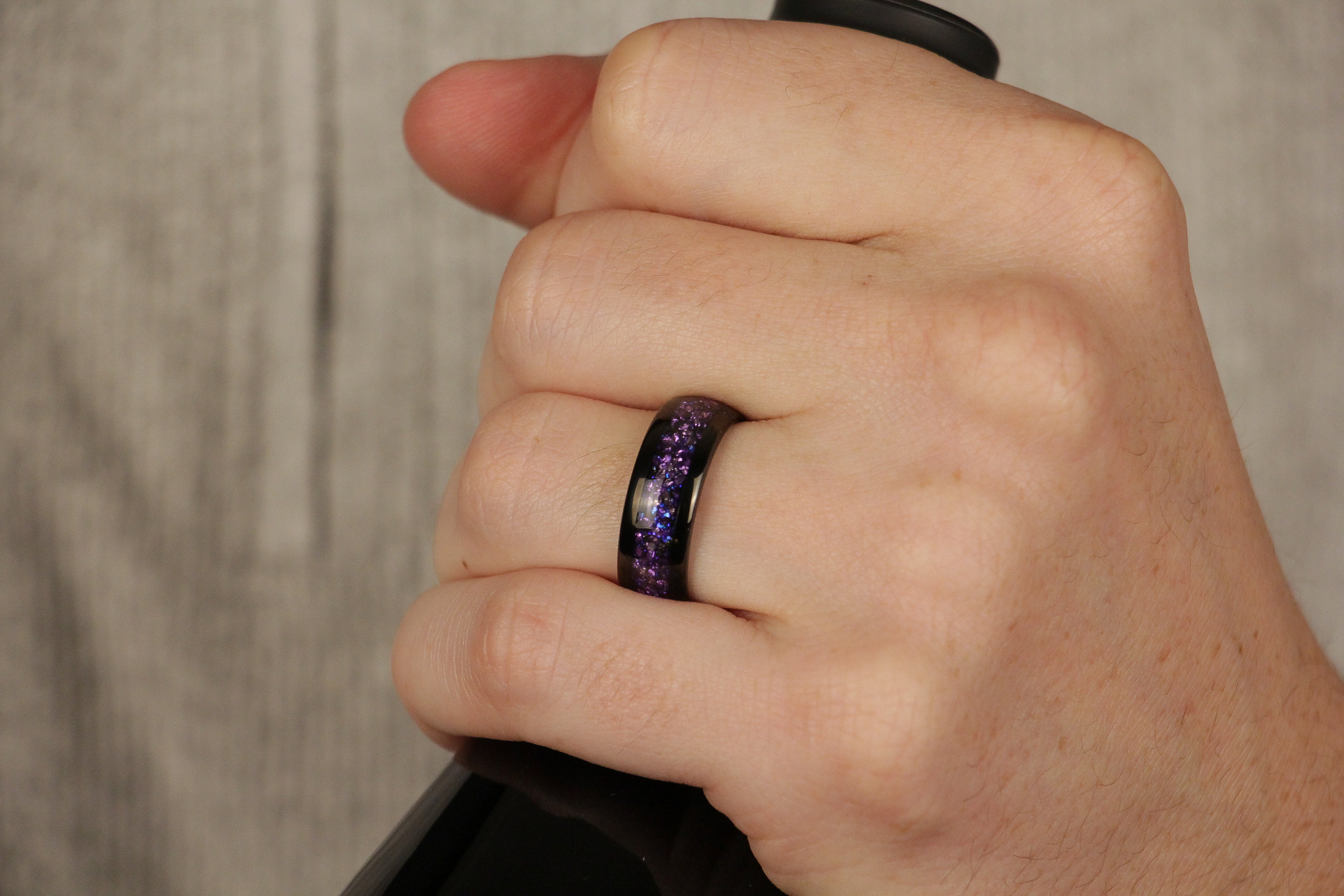 Black Tungsten ring, crushed purple alexandrite gemstone, 8mm polished Black comfort fit, mens wedding band, hand photo.