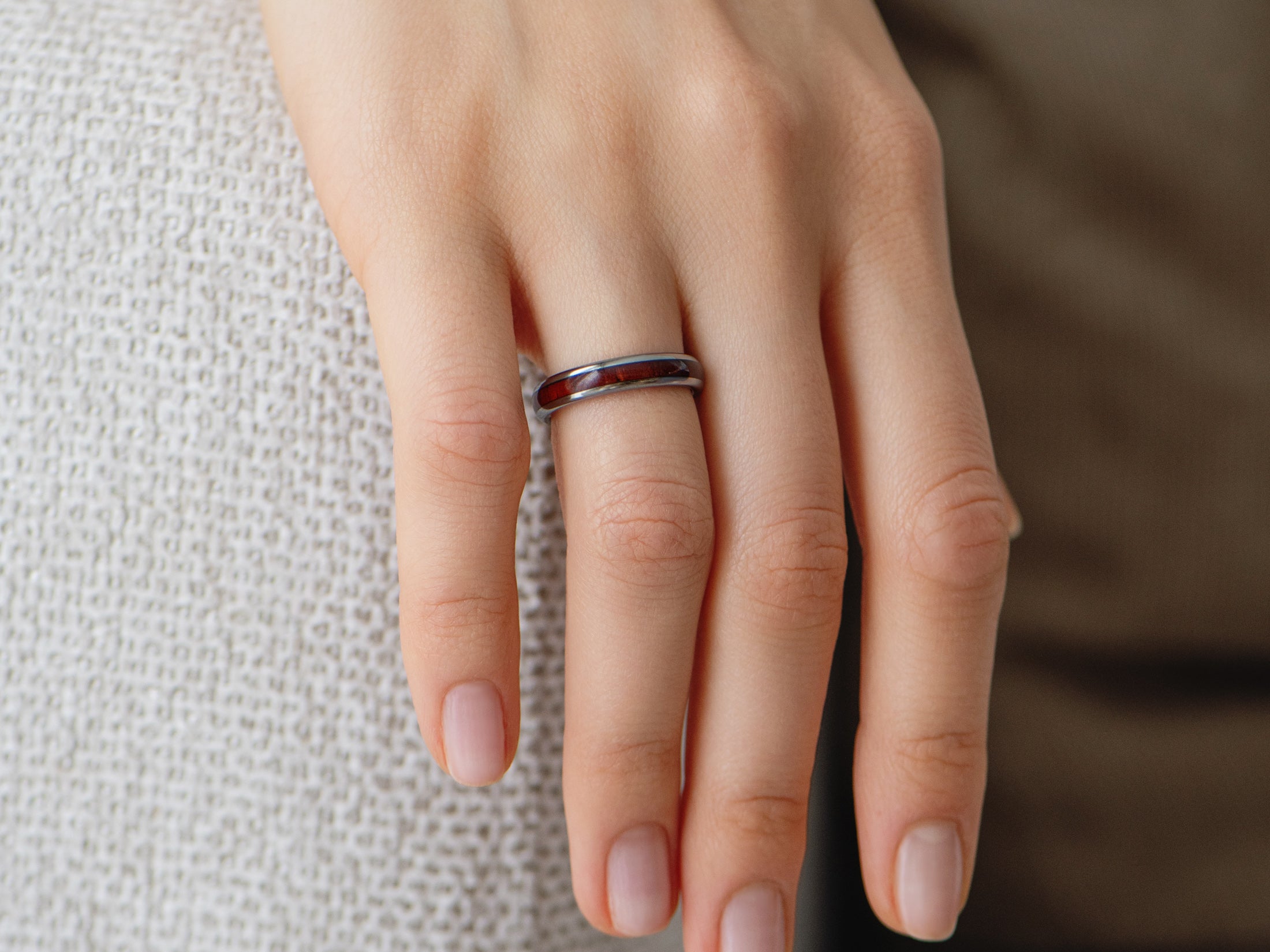 4mm silver tungsten ring with redwood inlay, womens hand photo