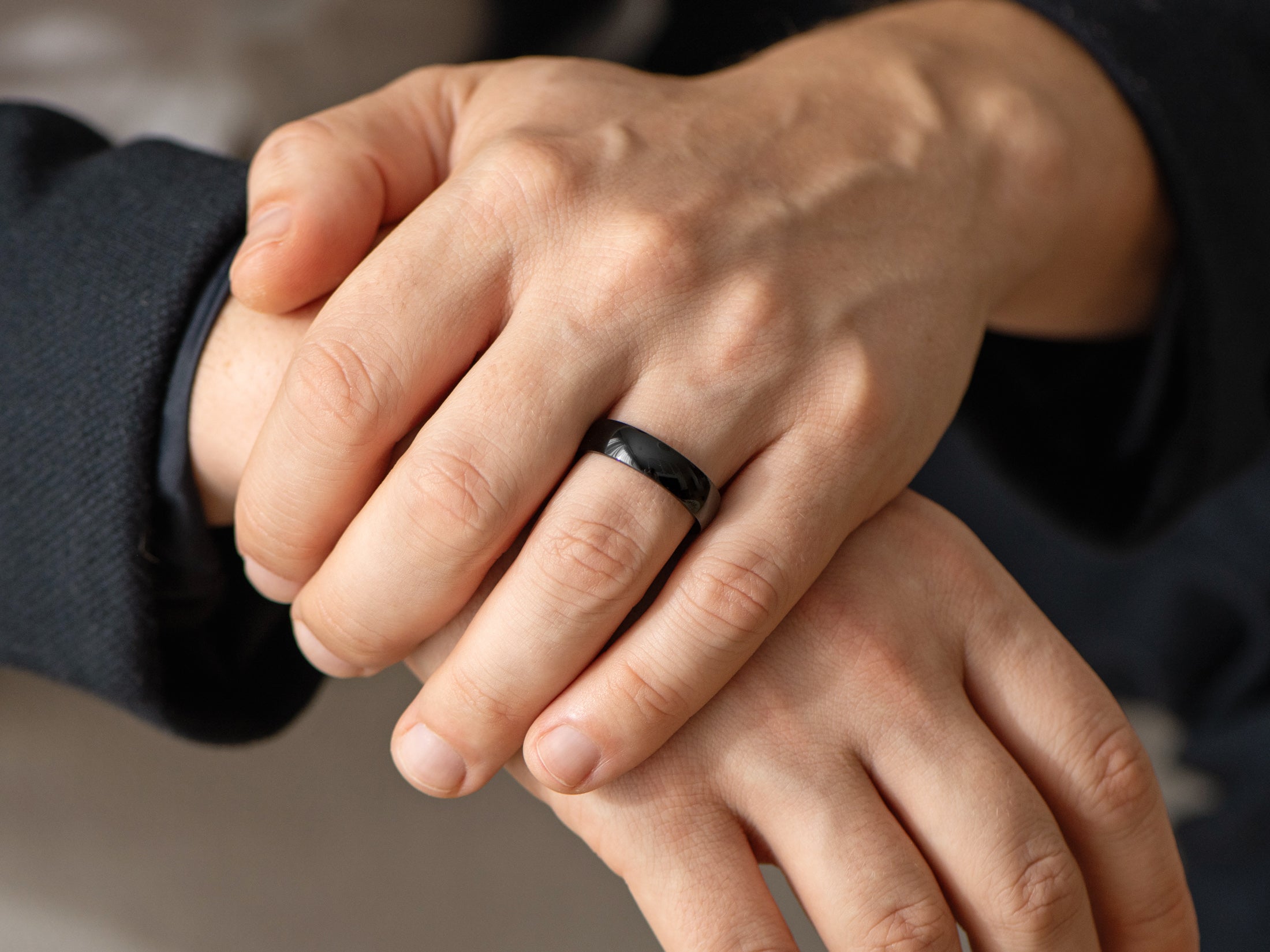 6mm polished black zirconium ring, mens hand photo