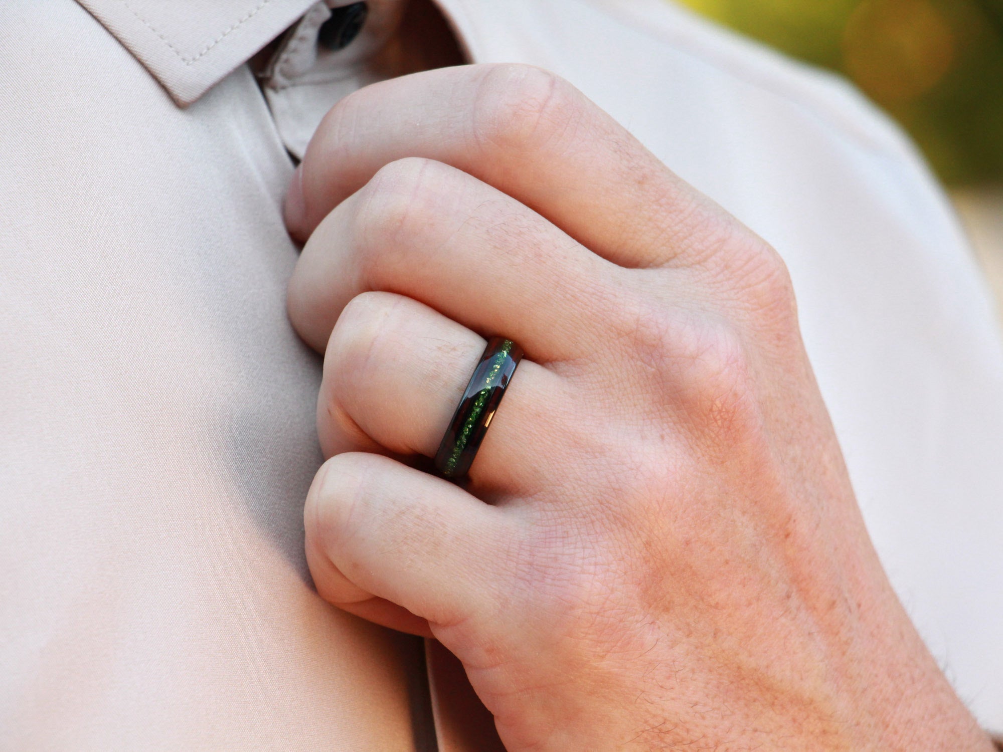 black redwood sapphire tungsten ring, redwood and lab created emerald inlay, 6mm black wedding band, mens hand photo