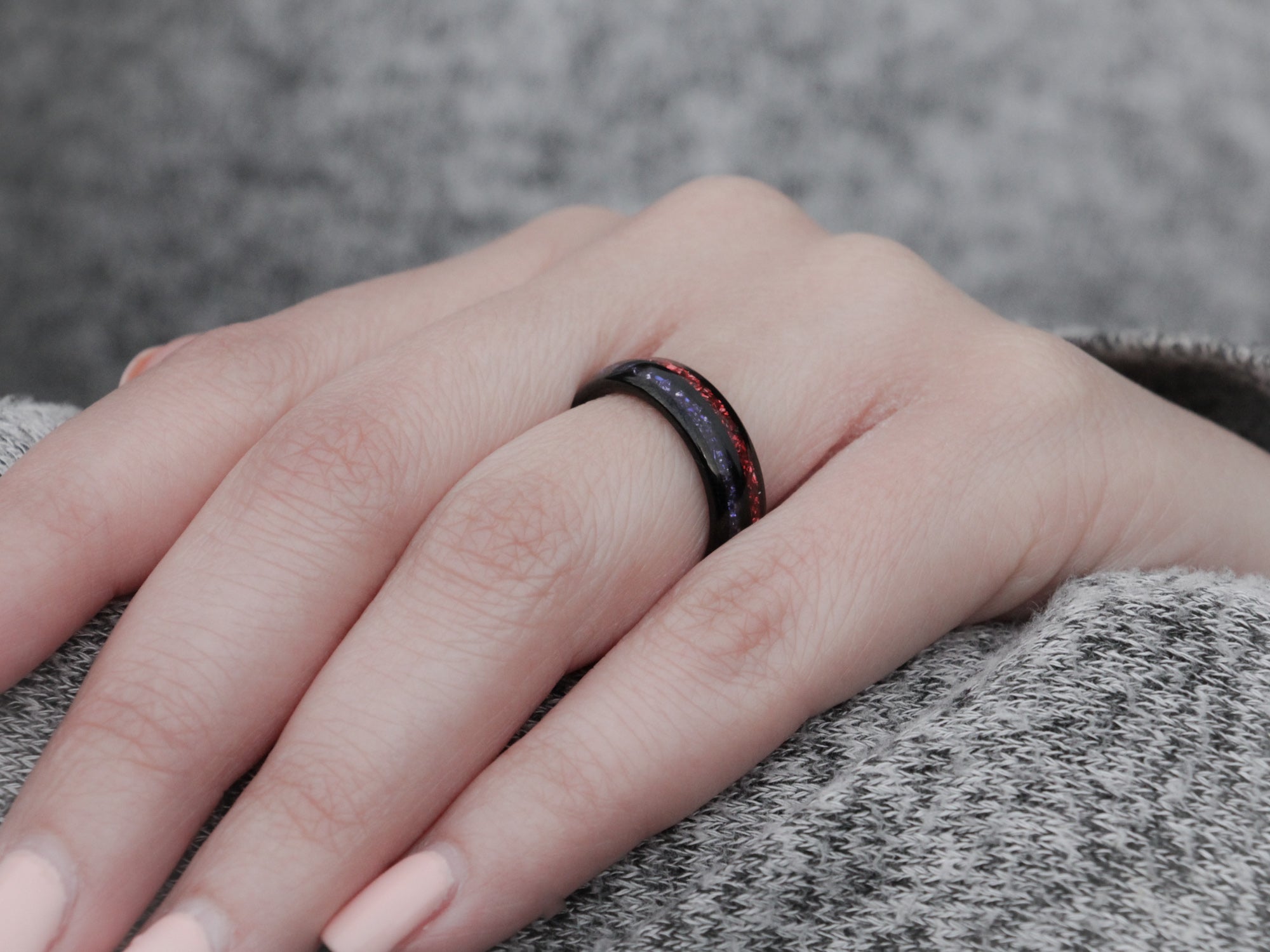 blue red black tungsten ring, lab grown sapphire and garnet gemstone inlay, 6mm polished black wedding band, womens hand photo